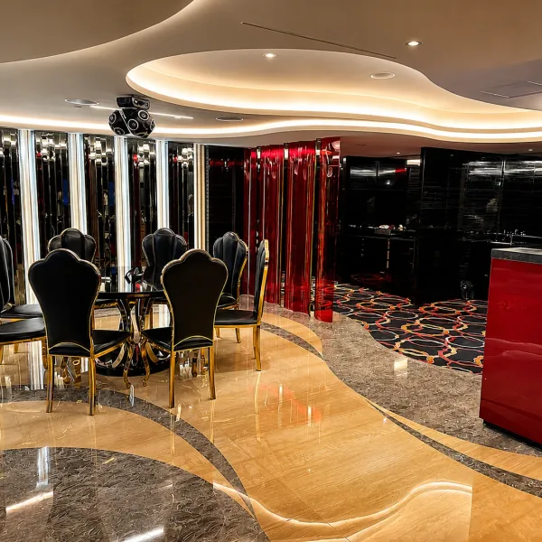 Mirror-lined dining lounge with black chairs and red counter