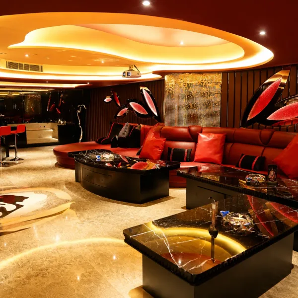 Red sculptural sofas in a warmly lit lounge