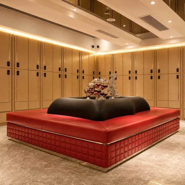 Beige locker room with a red centre bench