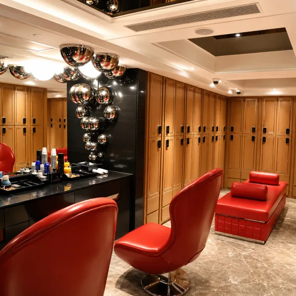Vanity counter with red chairs and timber lockers
