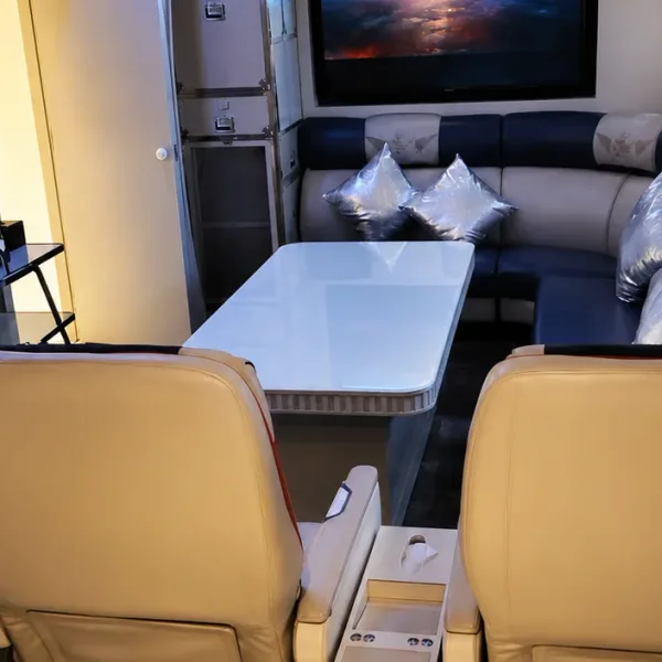 Aircraft cabin-themed lounge with cream seats