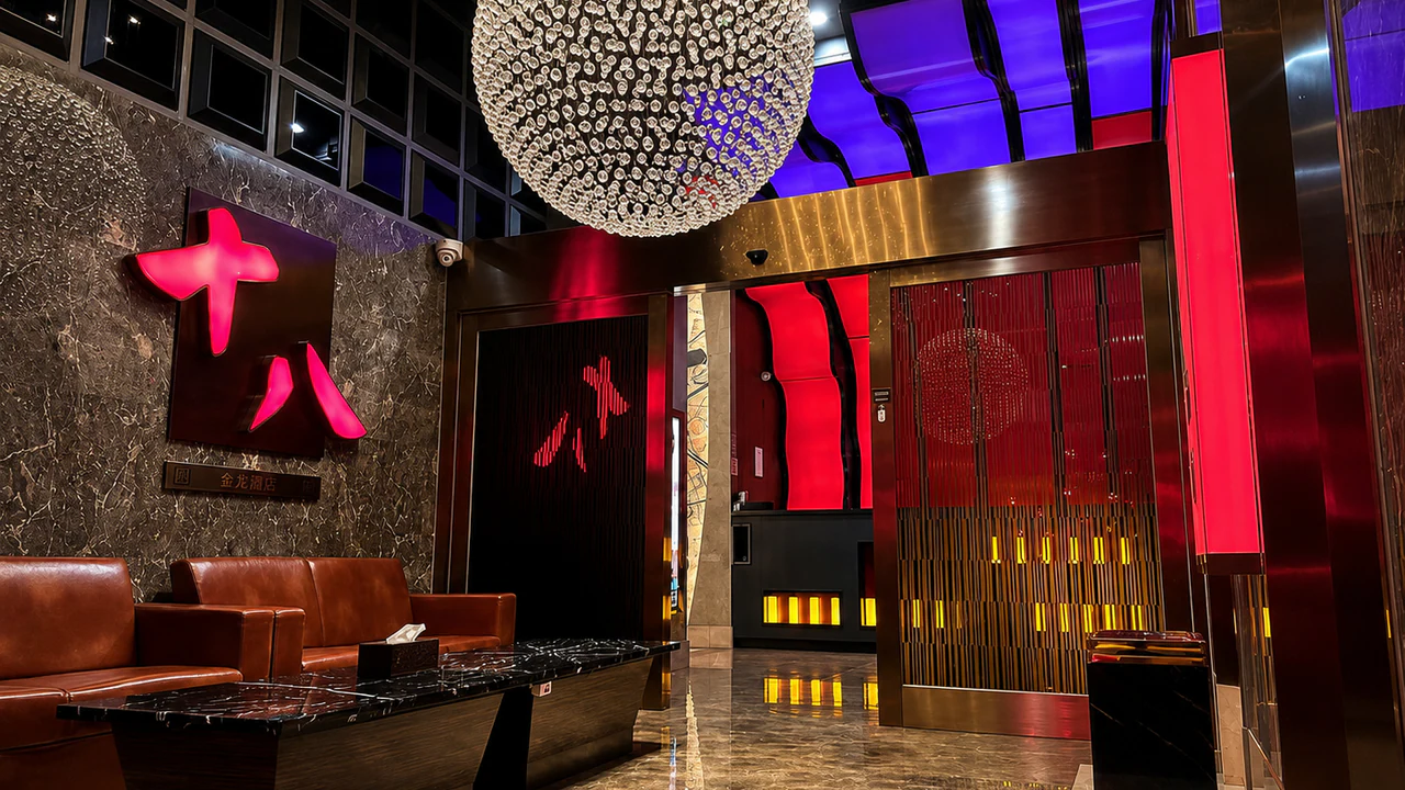 Red-and-black entrance lounge with leather sofas and a crystal chandelier