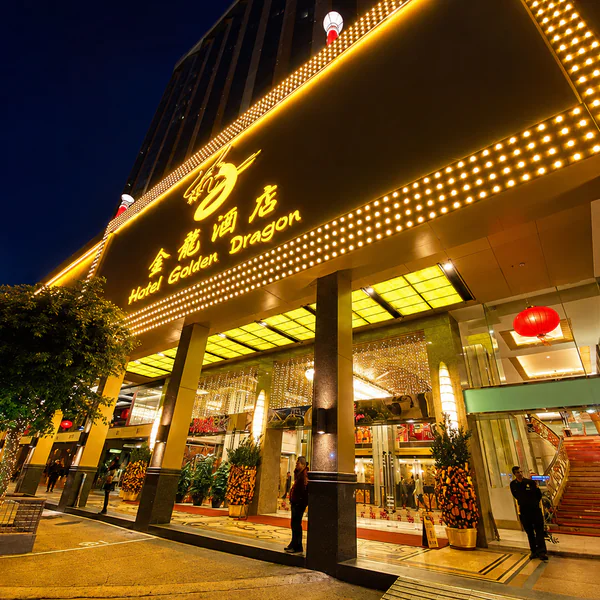 Hotel Golden Dragon entrance at night with gold signage and red lanterns