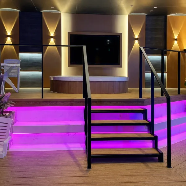 Raised lounge platform with pink illuminated steps