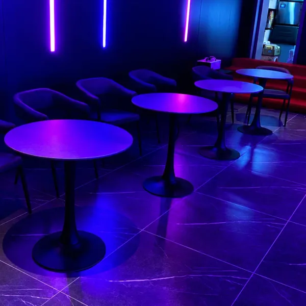 Purple neon lounge with round high tables