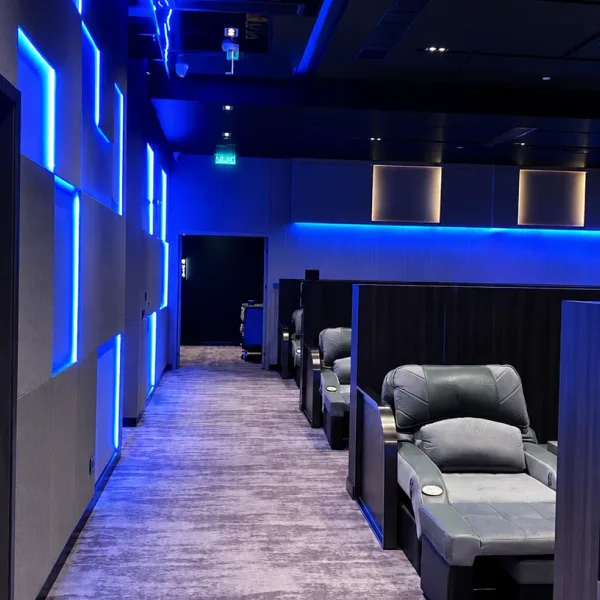 Blue-lit rest lounge with partitioned recliner rows
