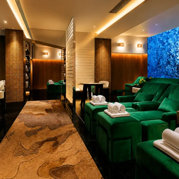 Green recliner lounge beside a blue textured wall
