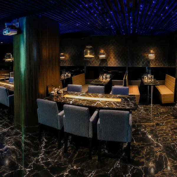 Marble-floored dining room with long table and bar shelves