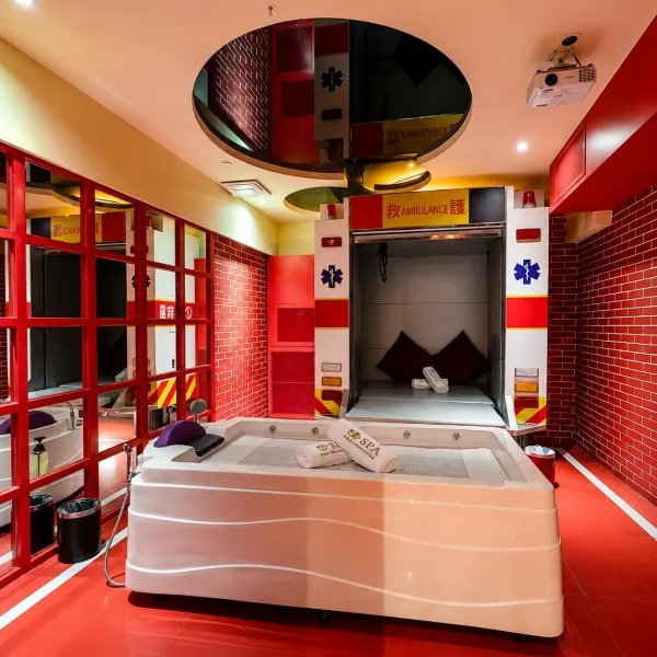 Red and white themed room with square whirlpool bath