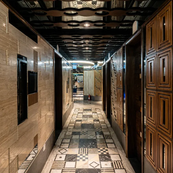 Long marble corridor with patterned monochrome floor