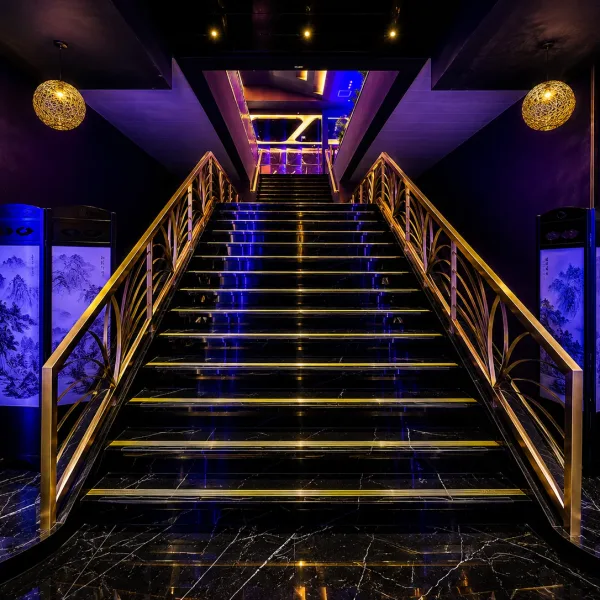 Purple-lit staircase with gold handrails