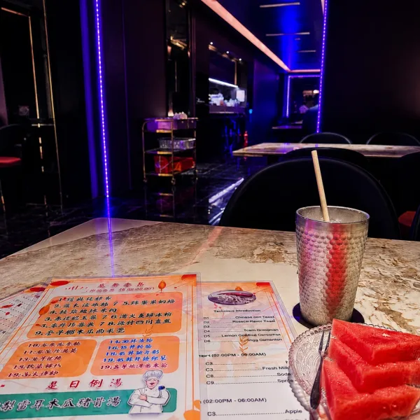 Printed menu and metal cup on a marble table