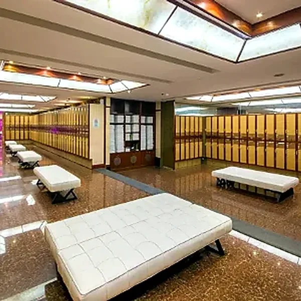 Spacious locker room with white resting benches