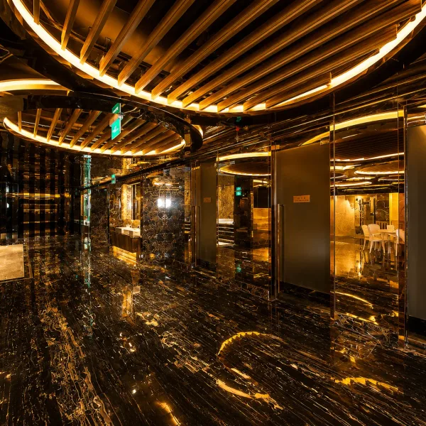 Glossy black marble corridor with mirrored doorways