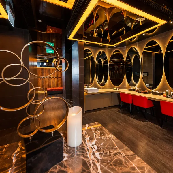 Curved counter with circular mirrors and gold accents