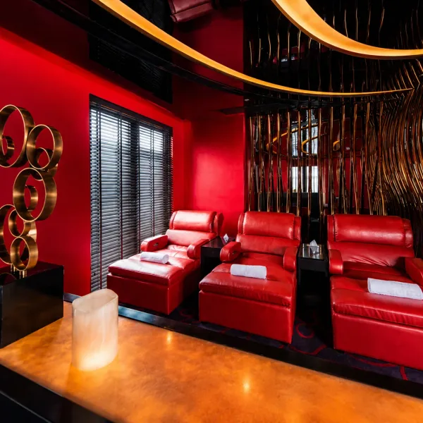 Three red recliners in a warm wood and black lounge