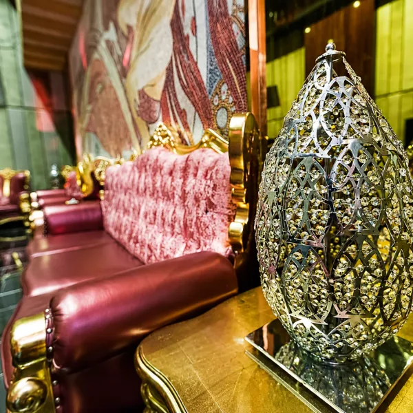 Ornate metal lanterns beside red leather seating