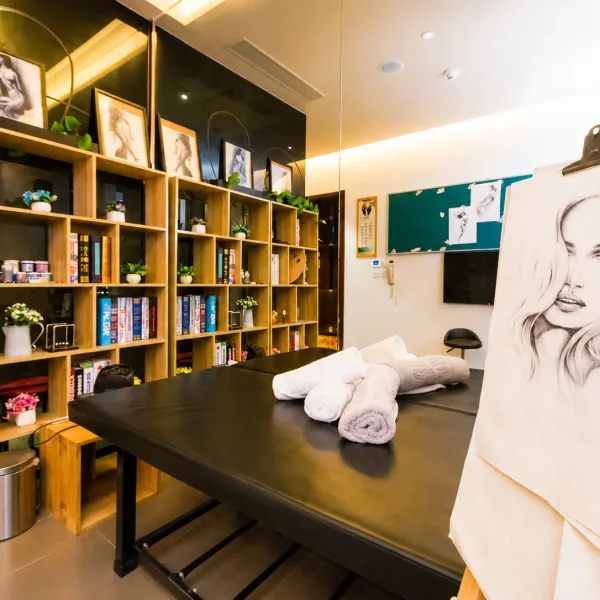 Bright studio-themed room with easels and bookshelves