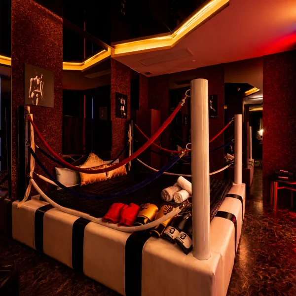 Wide view of a red and black suite with hanging seats