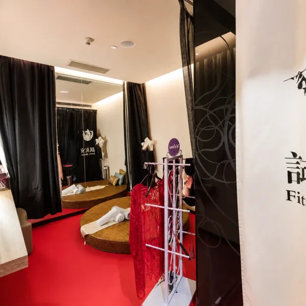 Fitting-room setting with round platforms and red carpet