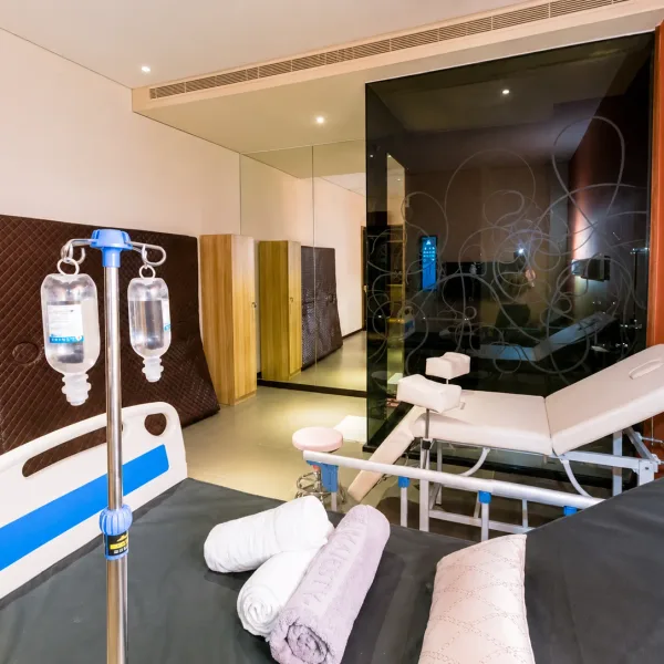 Clinical-themed room with adjustable beds and IV stands