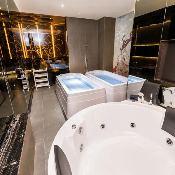 Black marble bathroom with round whirlpool tub