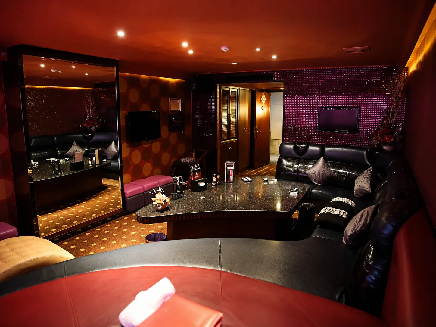 Red and black private lounge with curved seating