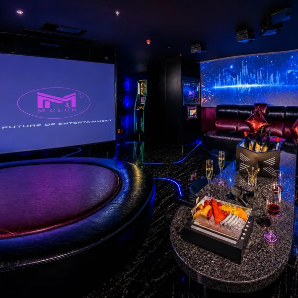 Private cinema lounge with projection screen and fruit table