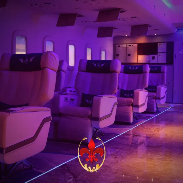 Purple-lit aircraft cabin with rows of reclining seats