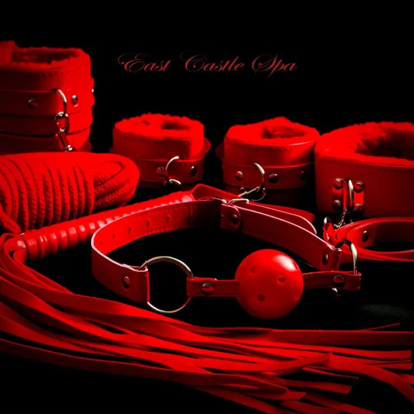 Red leather accessories arranged under crimson light