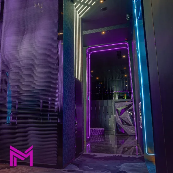 Purple neon doorway in a dark mirrored corridor