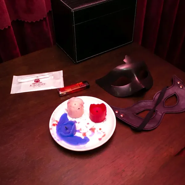 Masks and colourful themed accessories on a dark table
