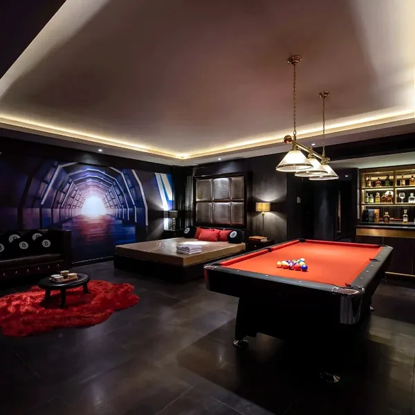 Entertainment lounge with pool table and cinema mural