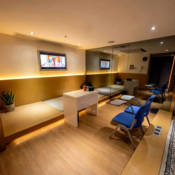 Bright treatment room with blue reclining chairs
