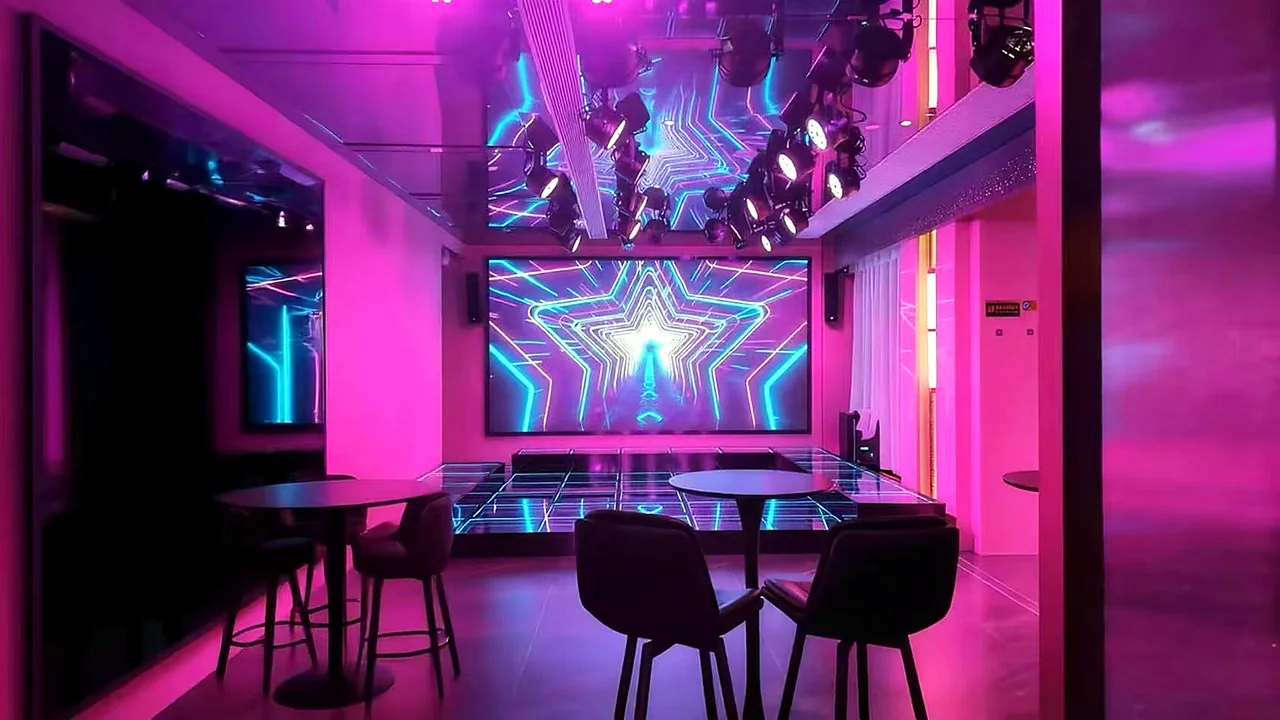 Neon pink performance lounge with star-pattern LED screen