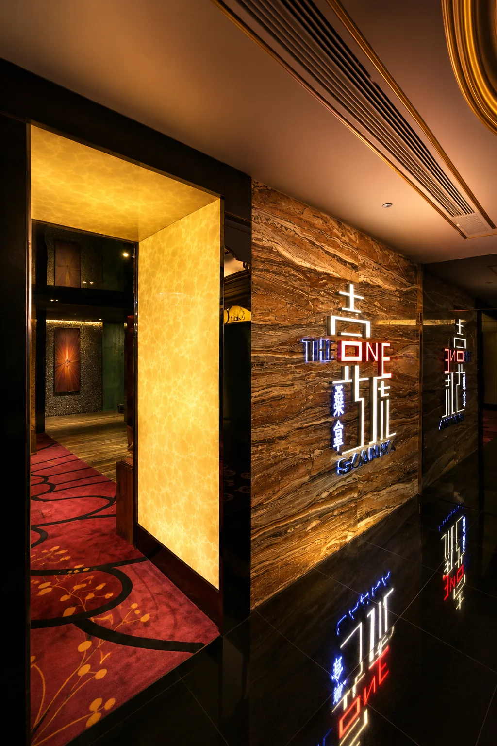 Black and gold lift lobby with illuminated wall graphics