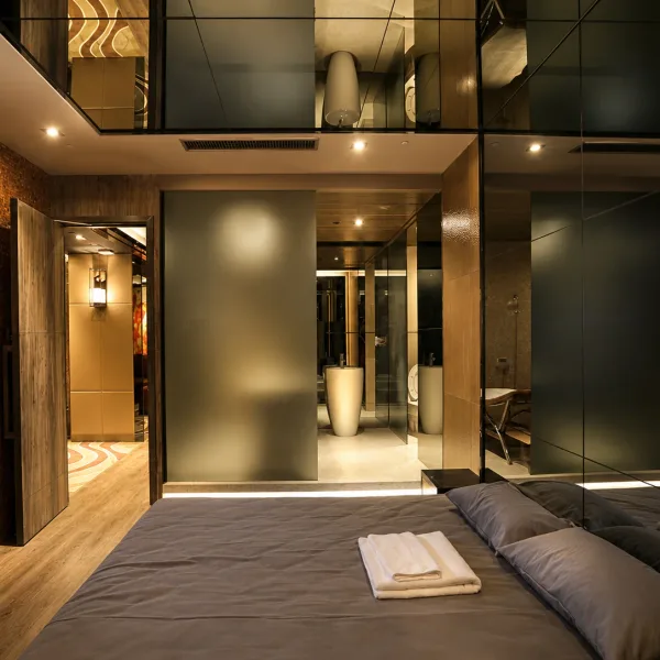 Four-poster bed beneath a mirrored geometric ceiling