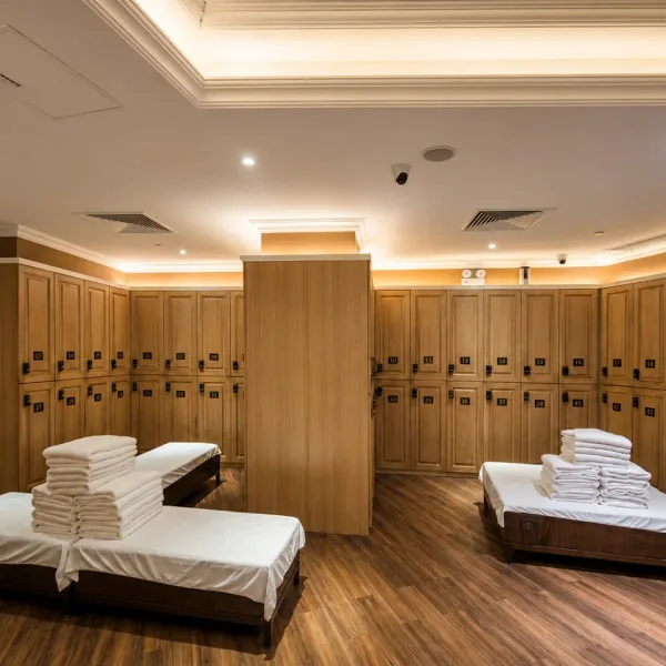 Wood locker room with towel-covered daybeds